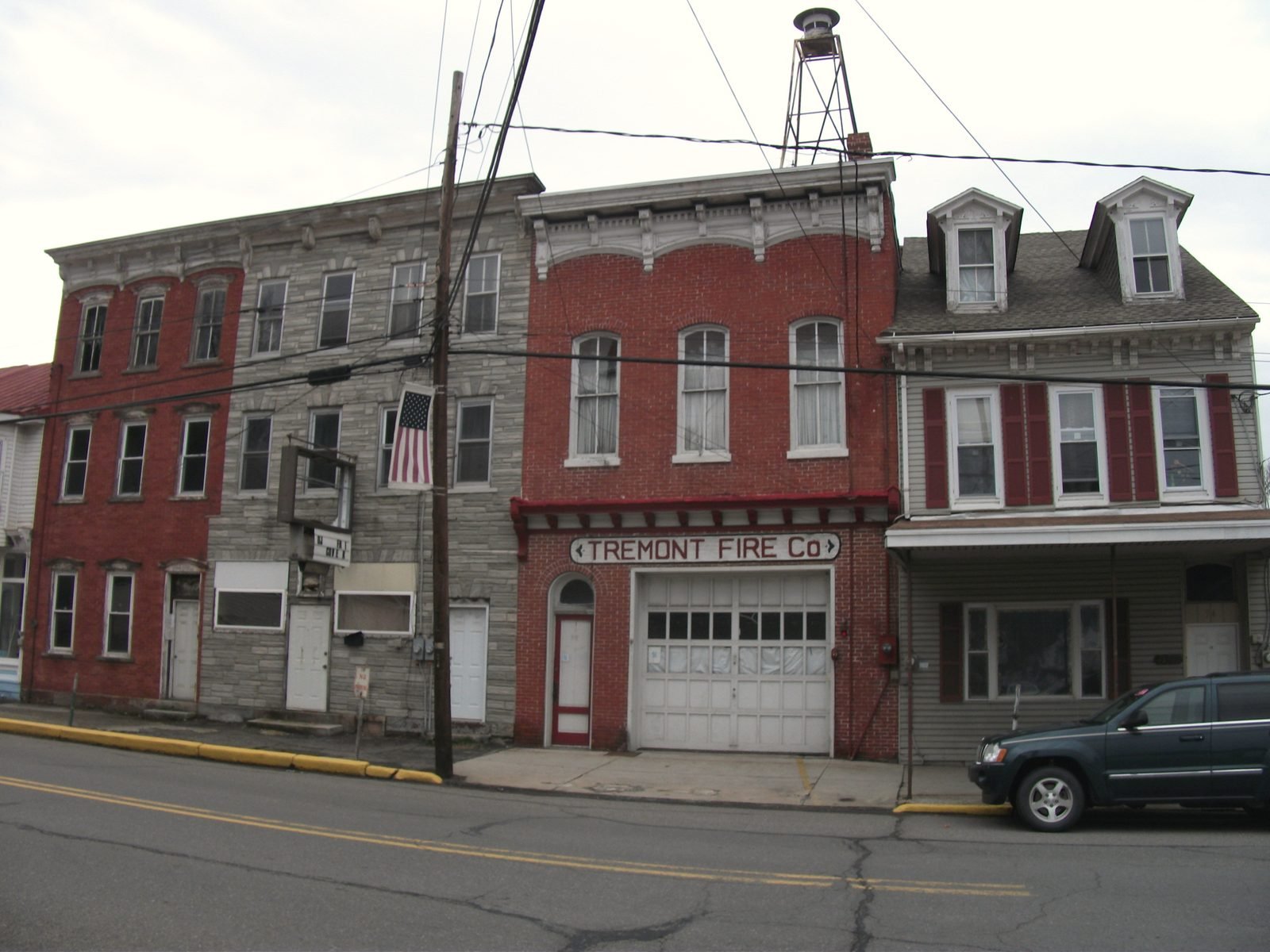 Brick commercial buildings and a firehouse on a street in Tremont, Pennsylvania